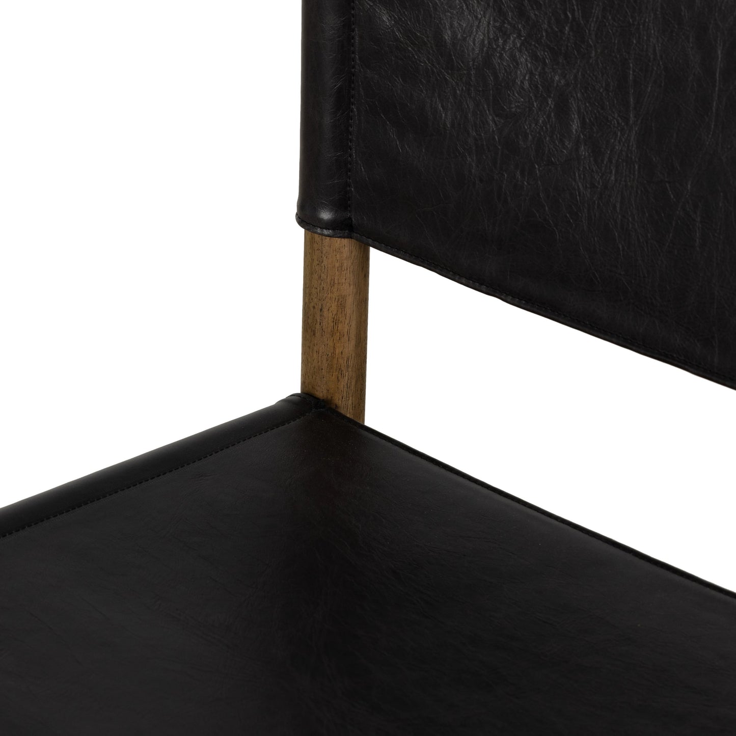 009 SI-1977440 | Closeup | Kena Dining Chair by Four Hands in sonoma black, vintage natural. Made from top grain leather, solid parawood in a modern style.