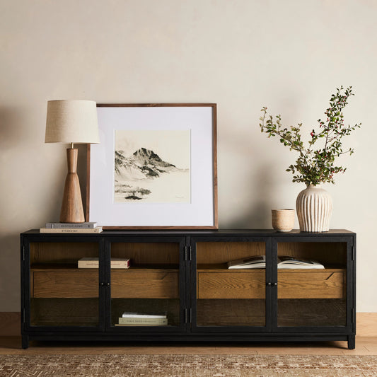 Millie Media Console by Four Hands in tempered glass, drifted black, drifted oak and matte black, drifted oak. Made from solid oak, tempered glass in a transitional style.