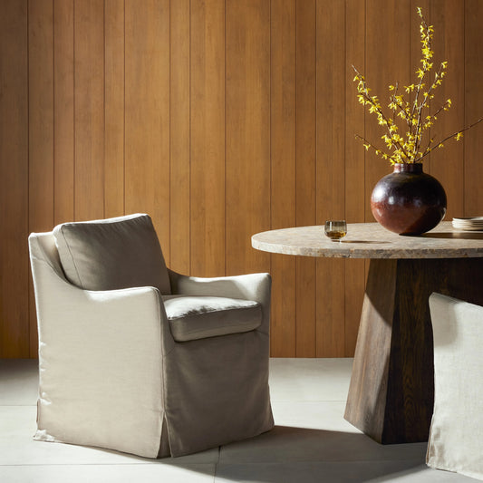 Monette Slipcover Dining Chair by Four Hands in brussels natural. Made from 100% flax, linen, 60% polyurethane foam, 20% fiber, 20% duck feather, 100% polyester in a modern style.