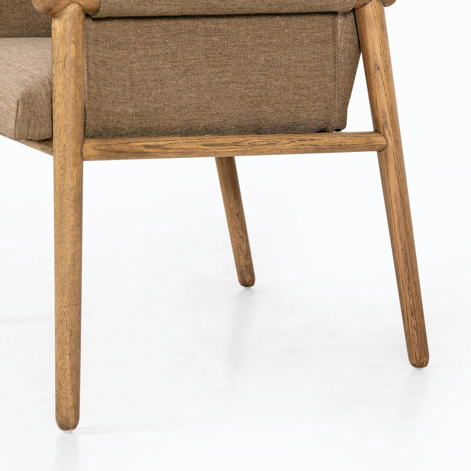 Almada Dining Armchair by Four Hands in valencia camel, distressed natural. Made from top grain leather, solid parawood, 100% polyester in a transitional style.