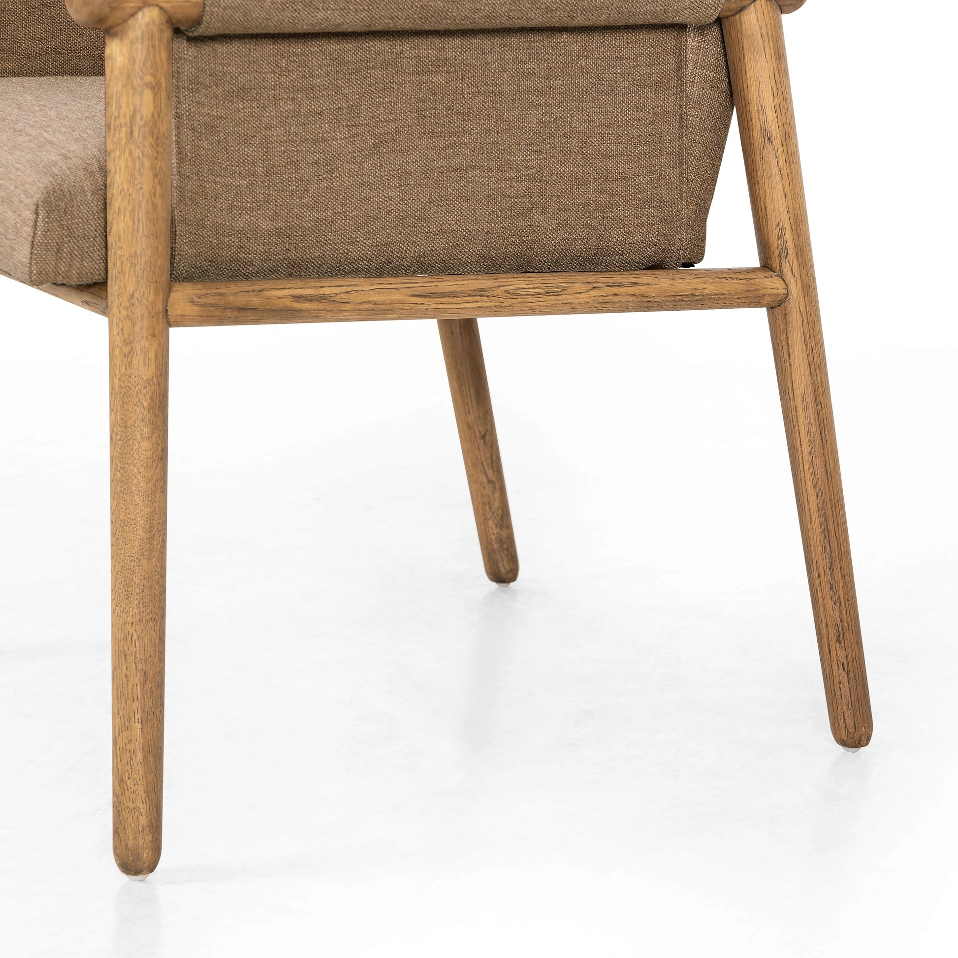 Almada Dining Armchair by Four Hands in valencia camel, distressed natural. Made from top grain leather, solid parawood, 100% polyester in a transitional style.