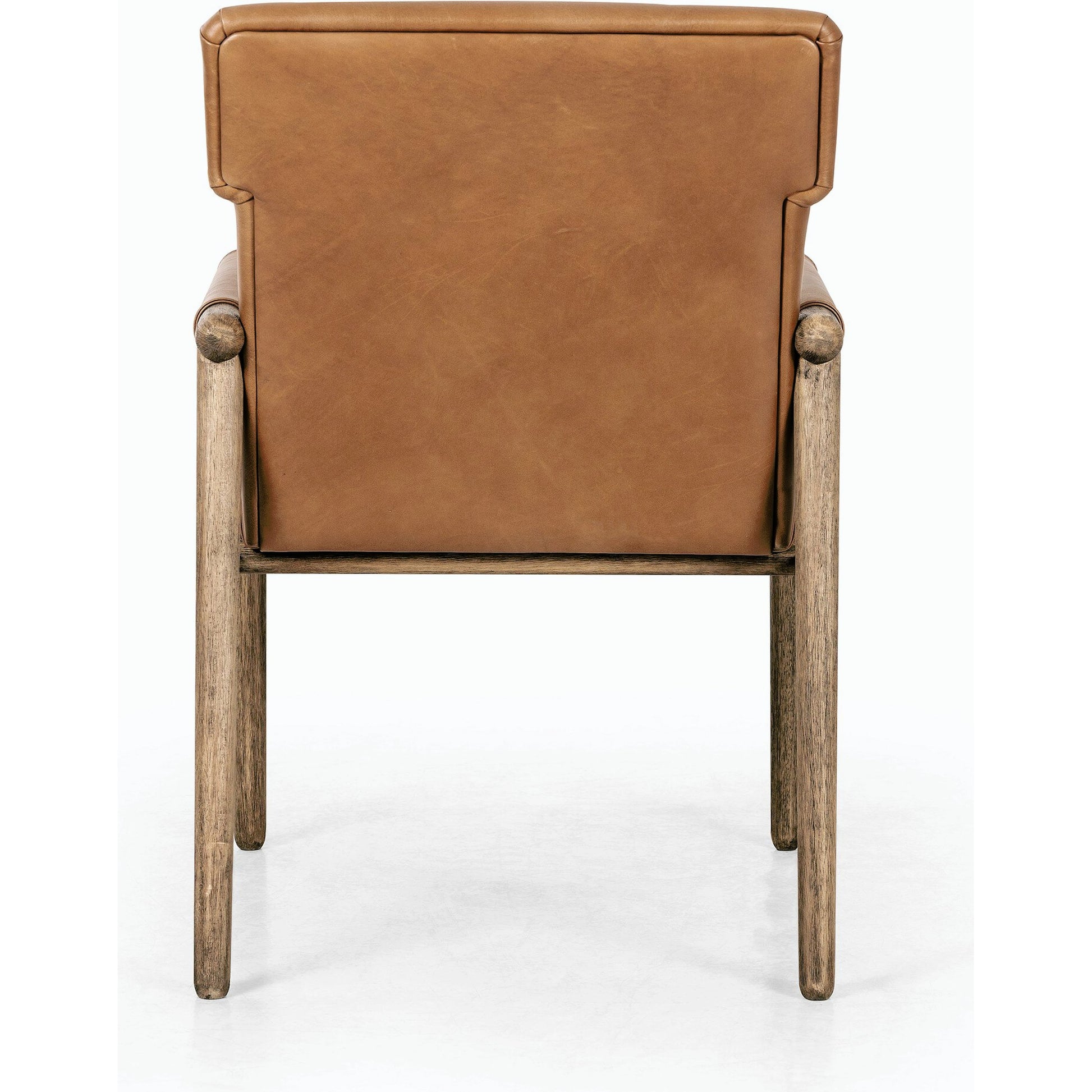 Almada Dining Armchair by Four Hands in valencia camel, distressed natural. Made from top grain leather, solid parawood, 100% polyester in a transitional style.