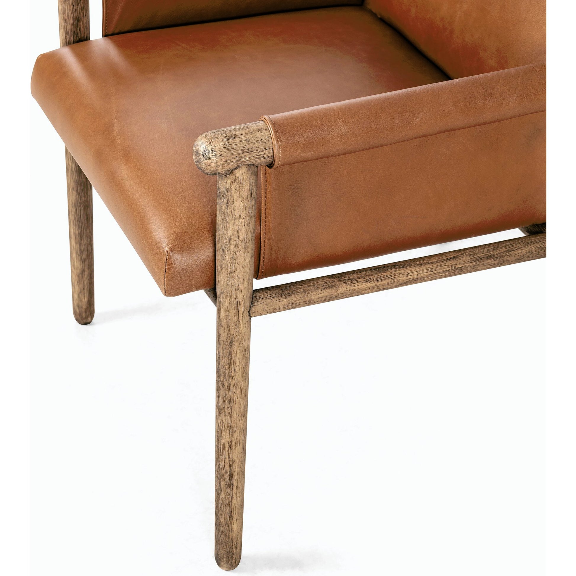 Almada Dining Armchair by Four Hands in valencia camel, distressed natural. Made from top grain leather, solid parawood, 100% polyester in a transitional style.