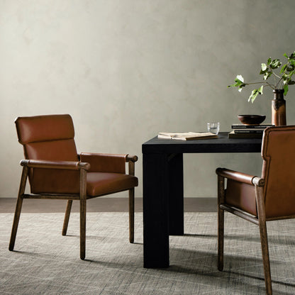 Almada Dining Armchair by Four Hands in valencia camel, distressed natural. Made from top grain leather, solid parawood, 100% polyester in a transitional style.