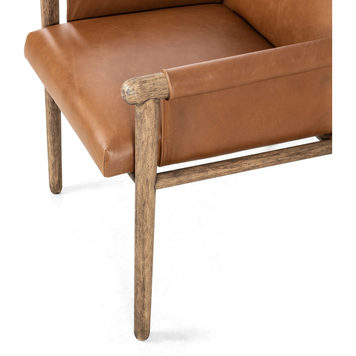 006 SI-1977004 | Closeup | Almada Dining Armchair by Four Hands in valencia camel, distressed natural. Made from top grain leather, solid parawood, 100% polyester in a transitional style.