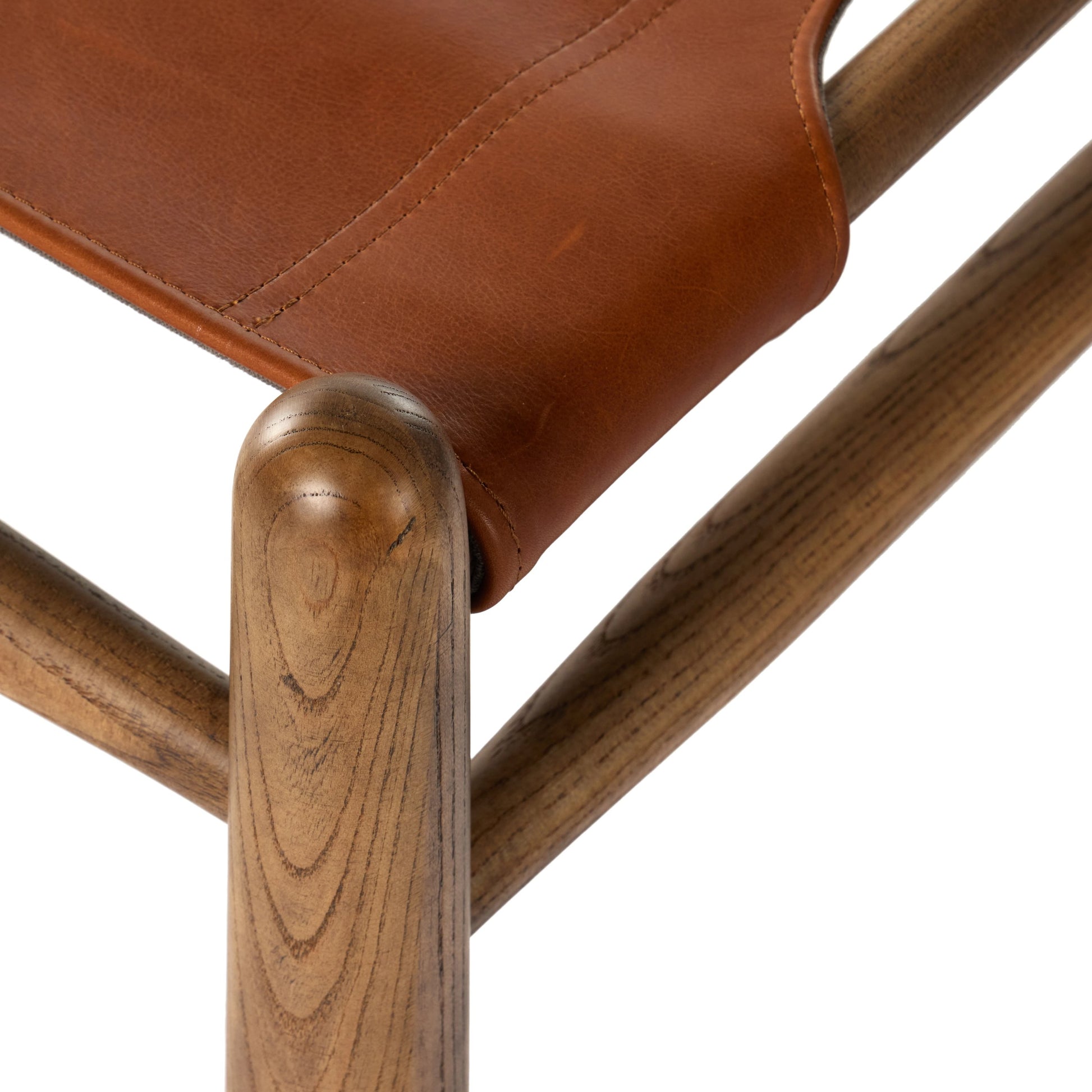 Nino Ottoman by Four Hands in dakota tobacco. Made from top grain leather, solid nettlewood, 100% polyester in a modern style.
