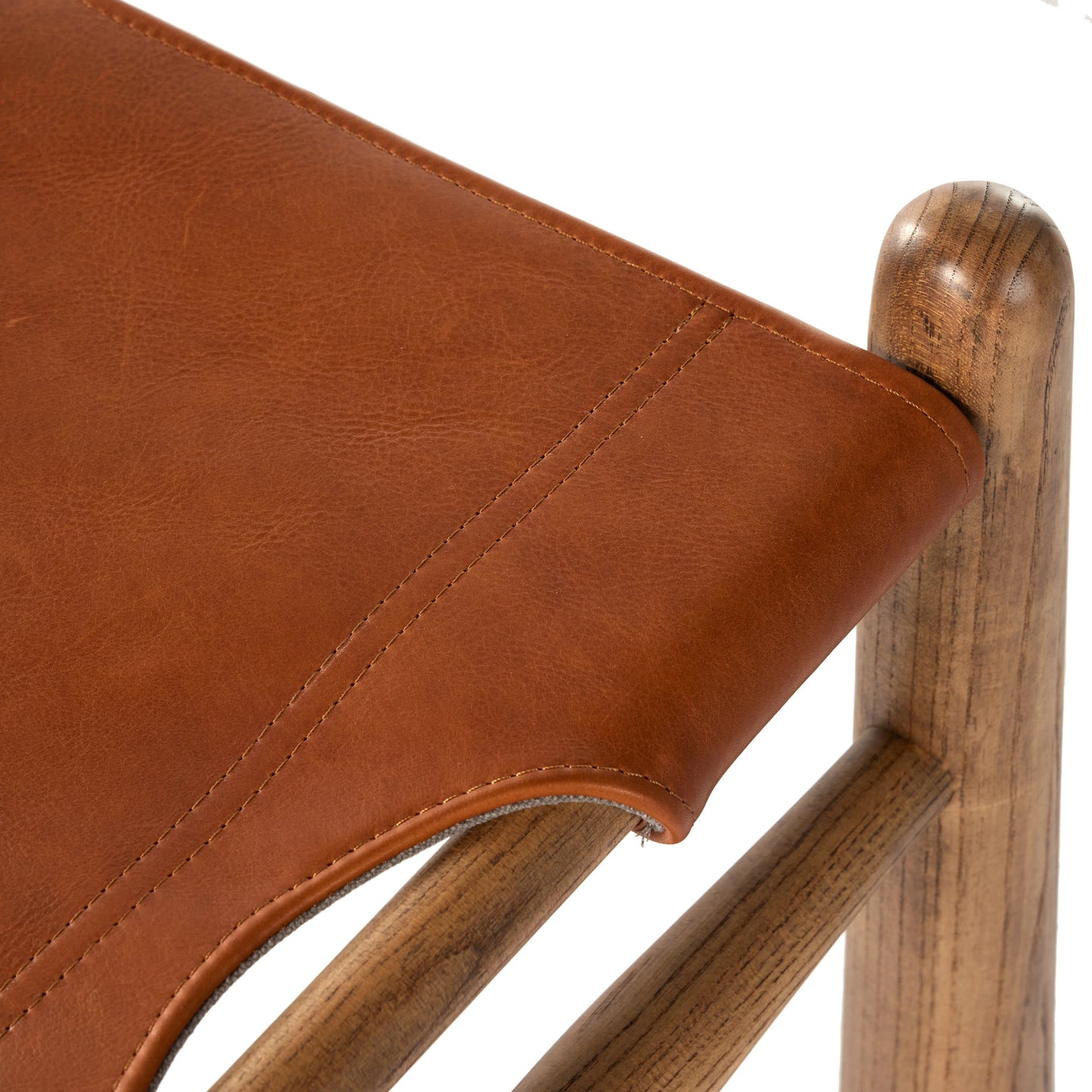 006 SI-2001738 | Closeup | Nino Ottoman by Four Hands in dakota tobacco. Made from top grain leather, solid nettlewood, 100% polyester in a modern style.