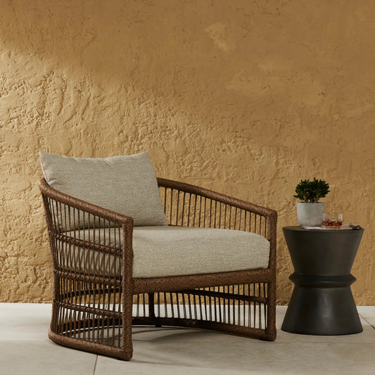 Montecito Outdoor Chair by Four Hands in faye sand, faux dark hyacinth. Made from 100% olefin, 100% polyethylene, 59% polyurethane foam, 30% polyester fiber, 11% polyester fiber batting in a modern style.