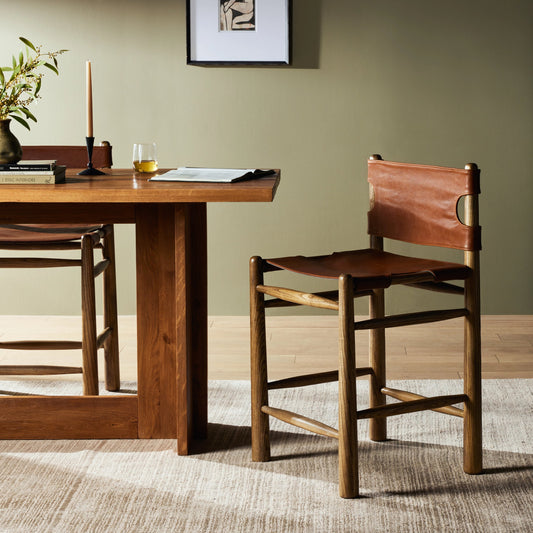Nino Counter Stool by Four Hands in dakota tobacco. Made from top grain leather, solid nettlewood, 100% polyester in a modern style.