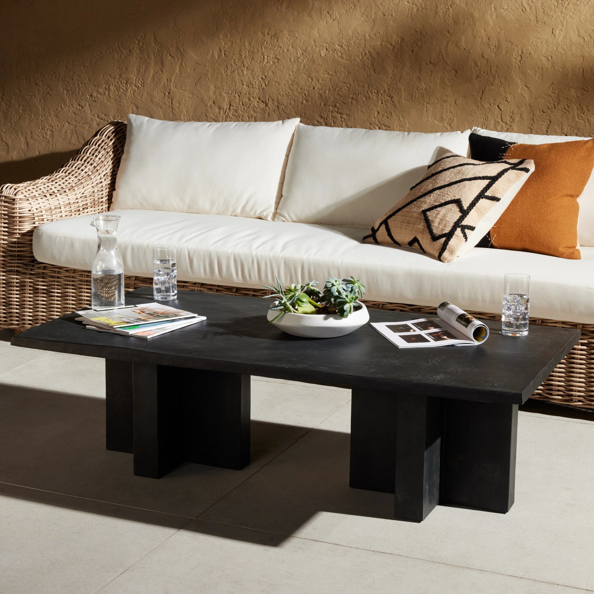 Terrell Outdoor Coffee Table by Four Hands in aged grey. Made from aluminum, engineered hardwood in a modern style.