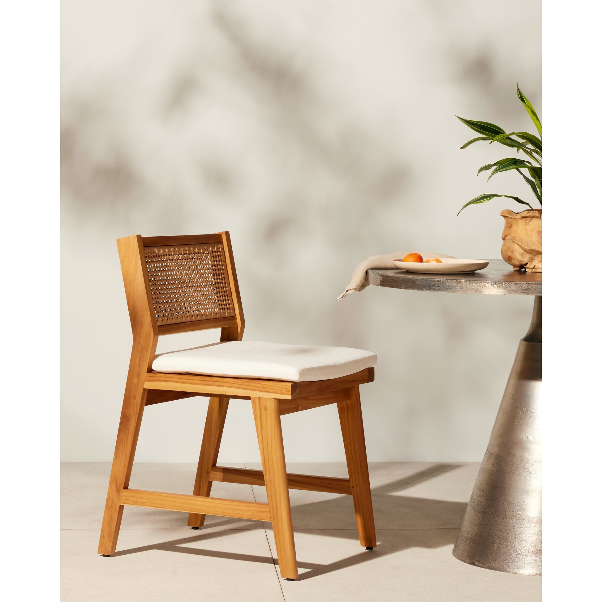 Merit Outdoor Dining Chair by Four Hands in faux rattan, natural teak. Made from solid fsc®-certified teak, 100% polyethylene in a transitional style.