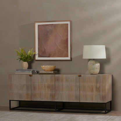 Kelby Closed Media Console by Four Hands in aged brass, carved vintage brown, vintage brown, gunmetal. Made from solid mango, iron in a modern style.