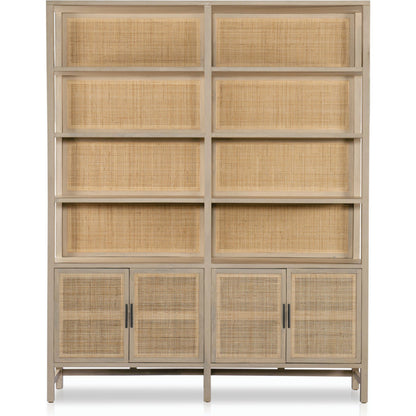 Caprice Wide Bookshelf by Four Hands in natural mango, gunmetal, natural cane and natural mango. Made from solid mango, iron in a modern style.