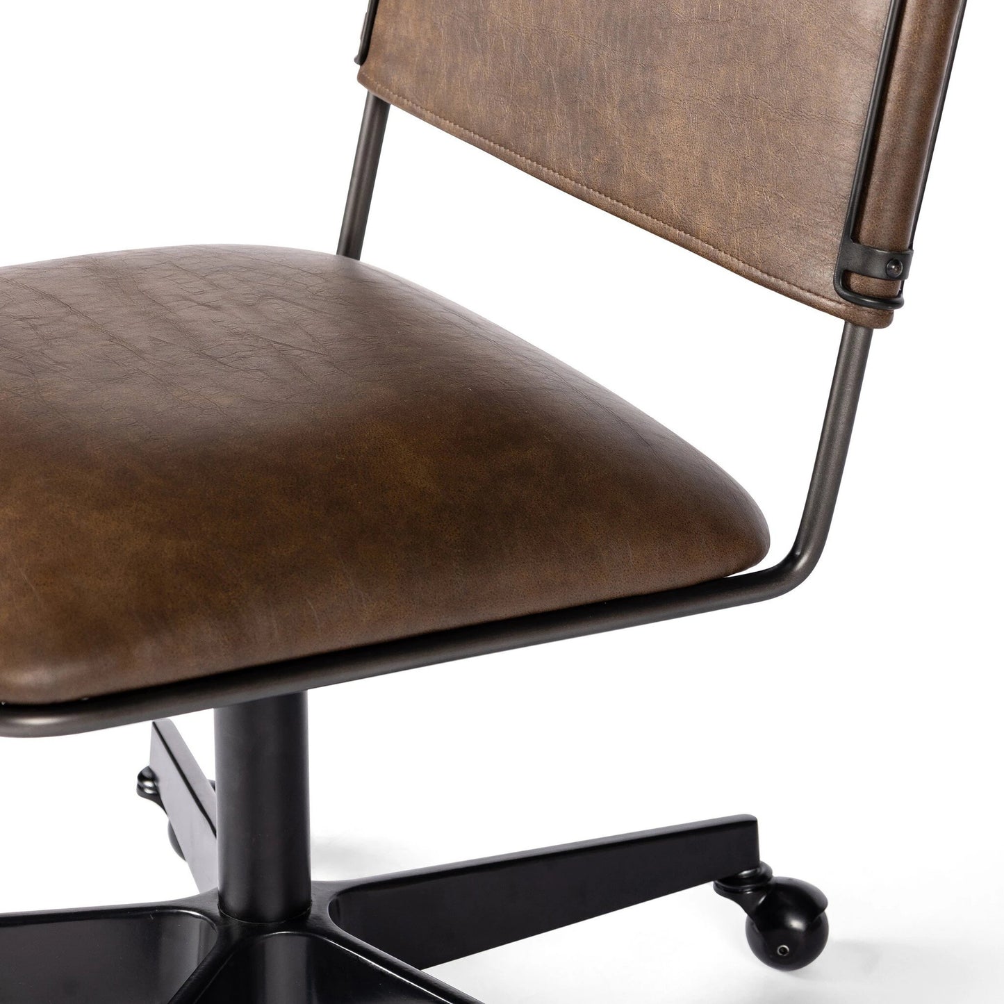 007 SI-2137713 | Closeup | Wharton Desk Chair by Four Hands in distressed brown. Made from faux leather, iron in a modern style.