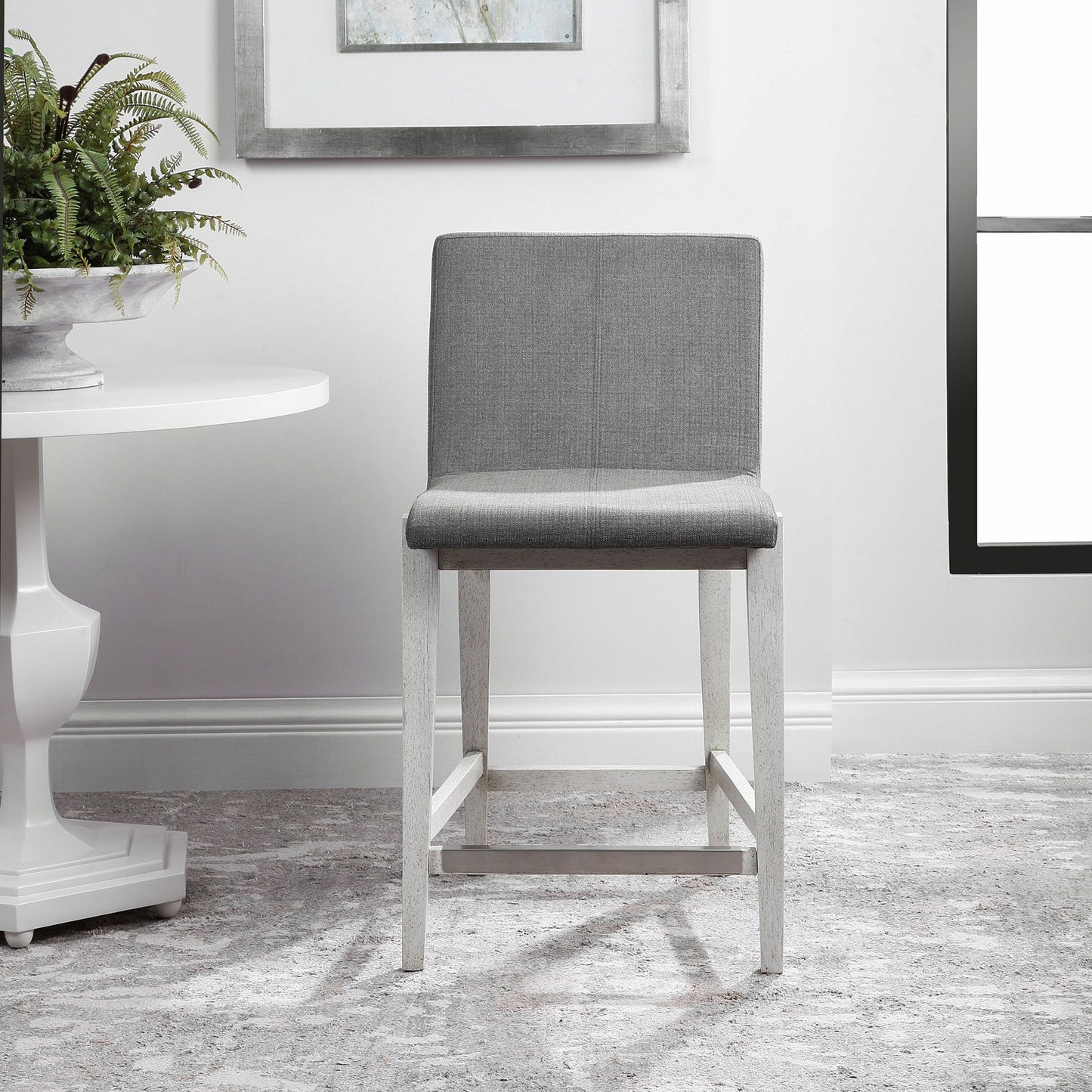 004 SR-801637 | Lifestyle | Brazos Counter Stool by Uttermost in gray. Made from rubber wood, plywood, fabric, foam in a modern style.