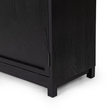 Millie Panel & Glass Door Cabinet by Four Hands in drifted matte black. Made from solid oak, oak veneer in a modern style.