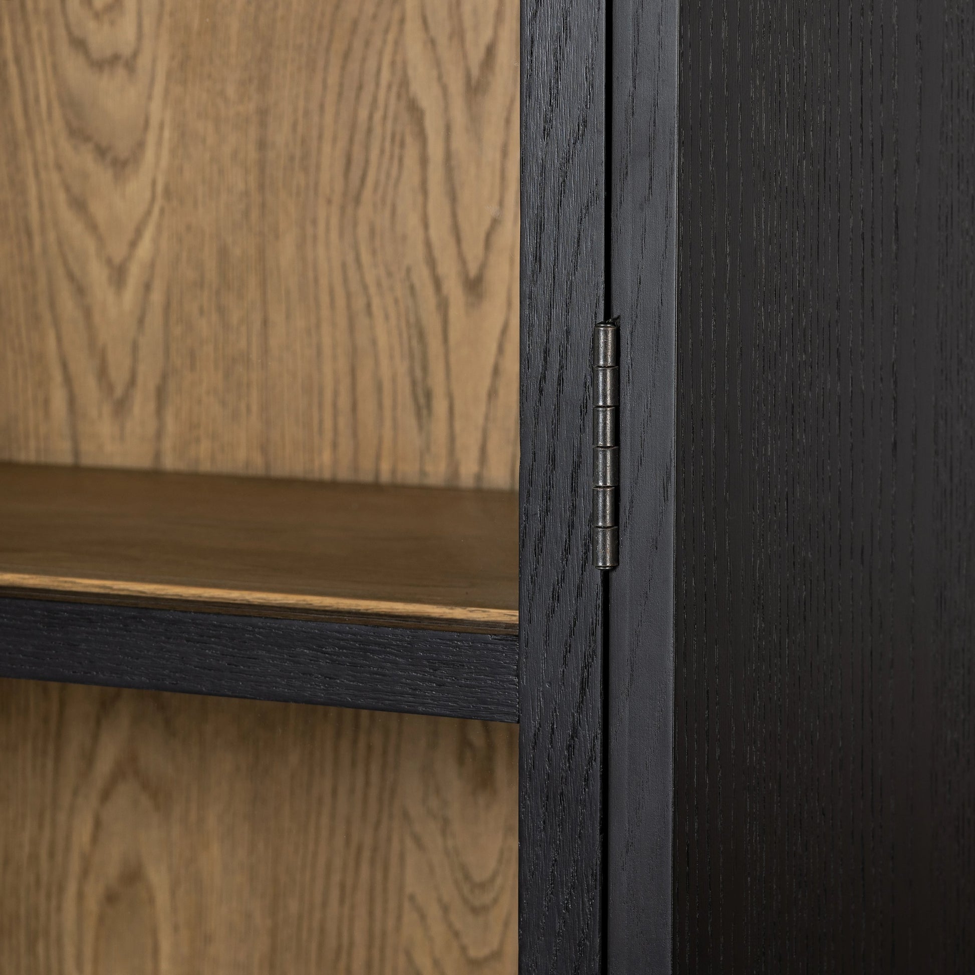 Millie Panel & Glass Door Cabinet by Four Hands in drifted matte black. Made from solid oak, oak veneer in a modern style.