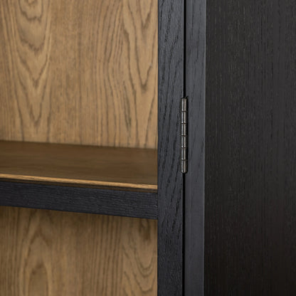 Millie Panel & Glass Door Cabinet by Four Hands in drifted matte black. Made from solid oak, oak veneer in a modern style.