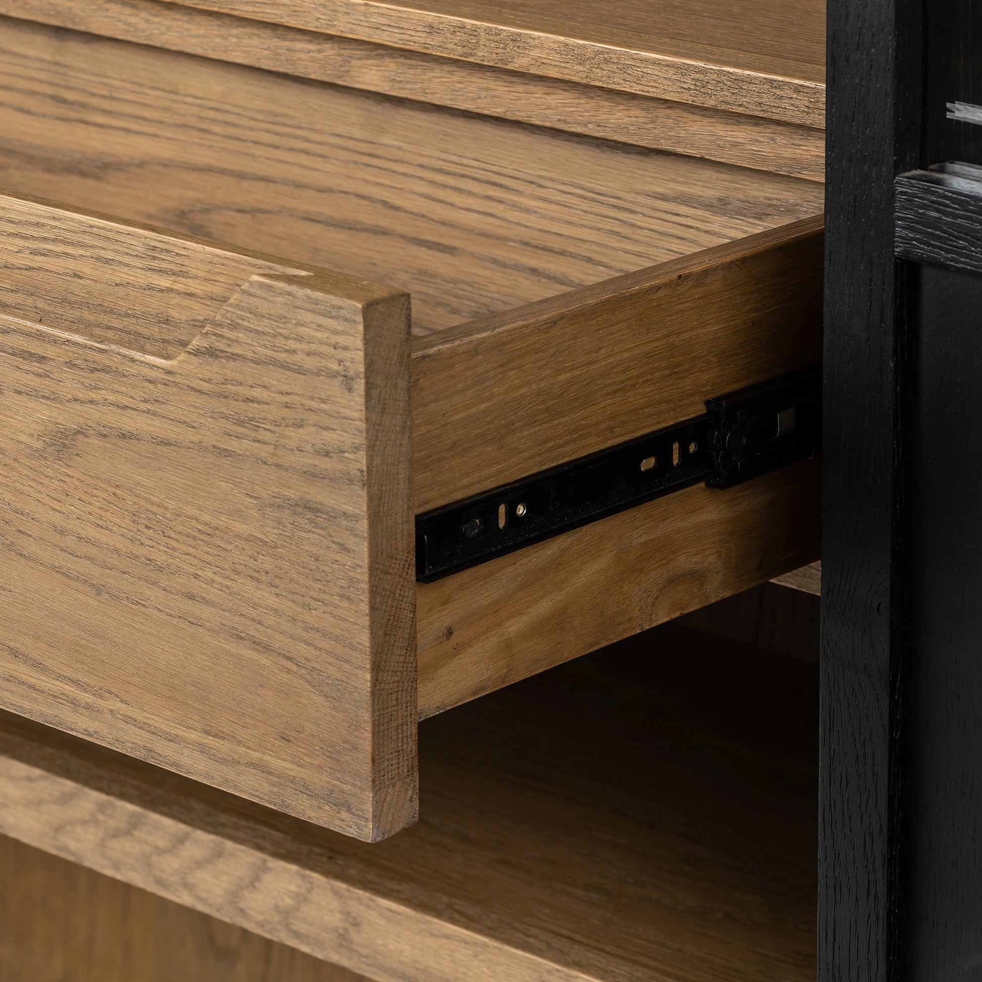 Millie Panel & Glass Door Cabinet by Four Hands in drifted matte black. Made from solid oak, oak veneer in a modern style.