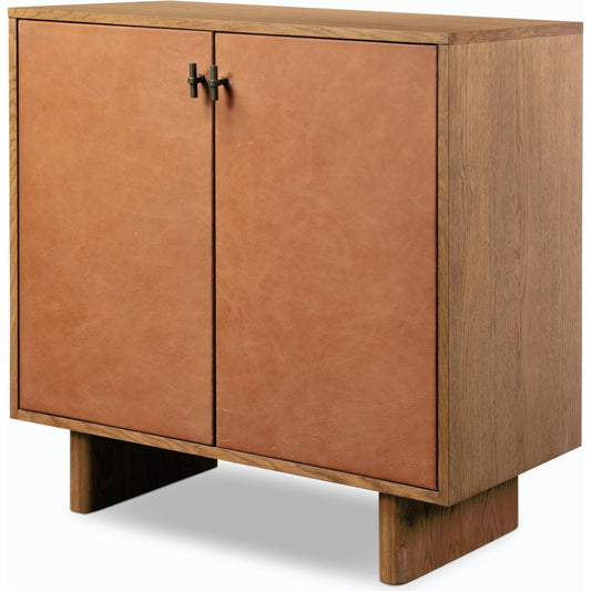 Posada Small Cabinet by Four Hands in amber oak veneer (incorrect material), palermo cognac and amber oak veneer (incorrect material). Made from thick oak veneer, top grain leather, solid oak in a modern style.