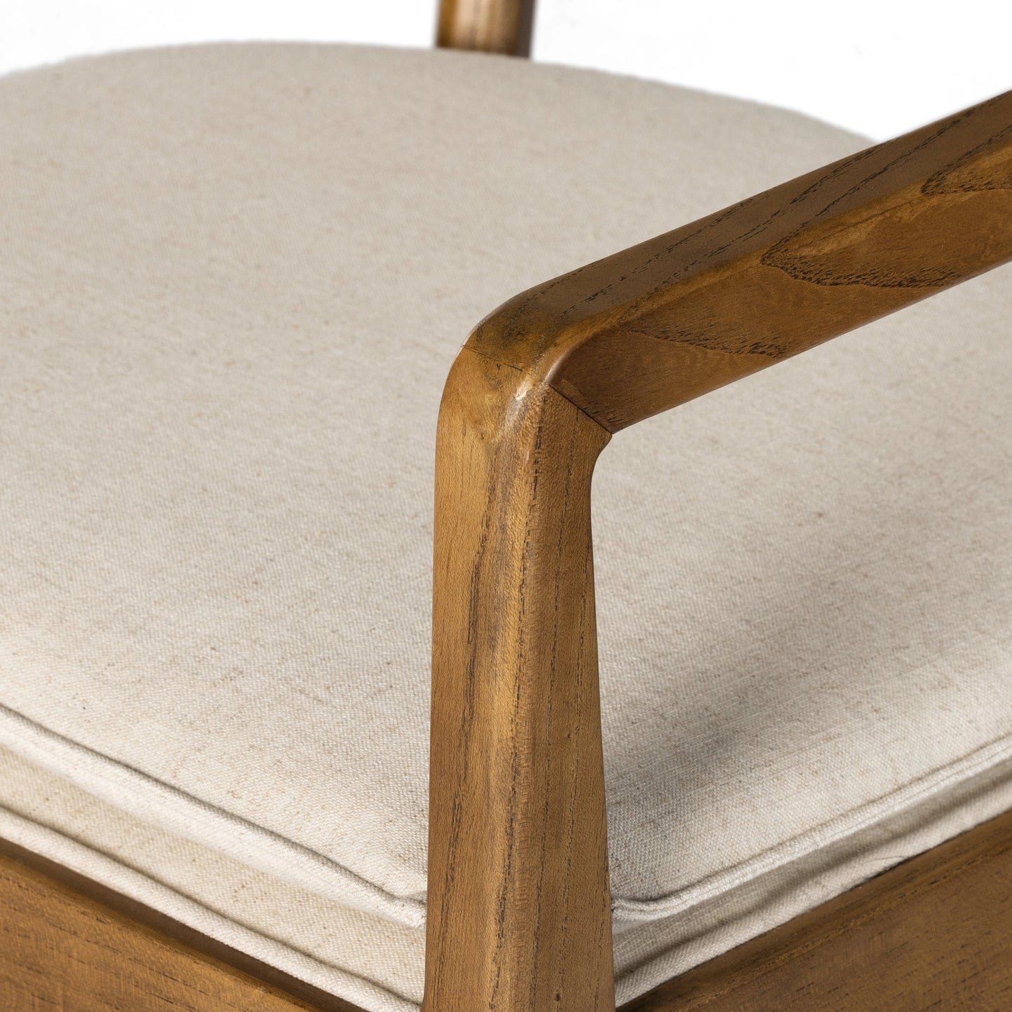 018 SI-1980147 | Closeup | Britt Dining Armchair by Four Hands in natural cane, toasted nettlewood, savile flax. Made from 92% polyester, 8% flax, linen, solid nettlewood, cane in a modern style.