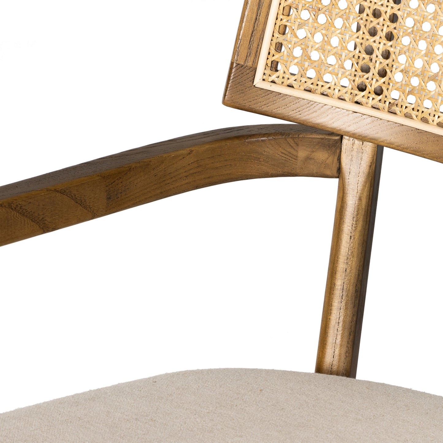 020 SI-1980147 | Closeup | Britt Dining Armchair by Four Hands in natural cane, toasted nettlewood, savile flax. Made from 92% polyester, 8% flax, linen, solid nettlewood, cane in a modern style.