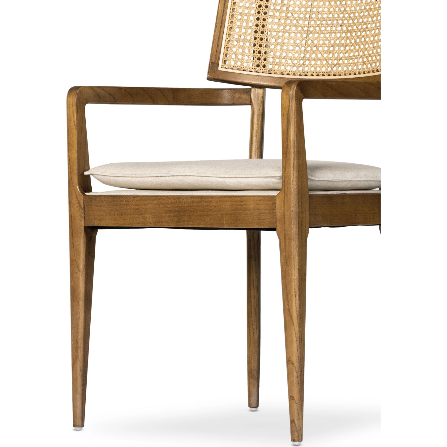 022 SI-1980147 | Closeup | Britt Dining Armchair by Four Hands in natural cane, toasted nettlewood, savile flax. Made from 92% polyester, 8% flax, linen, solid nettlewood, cane in a modern style.