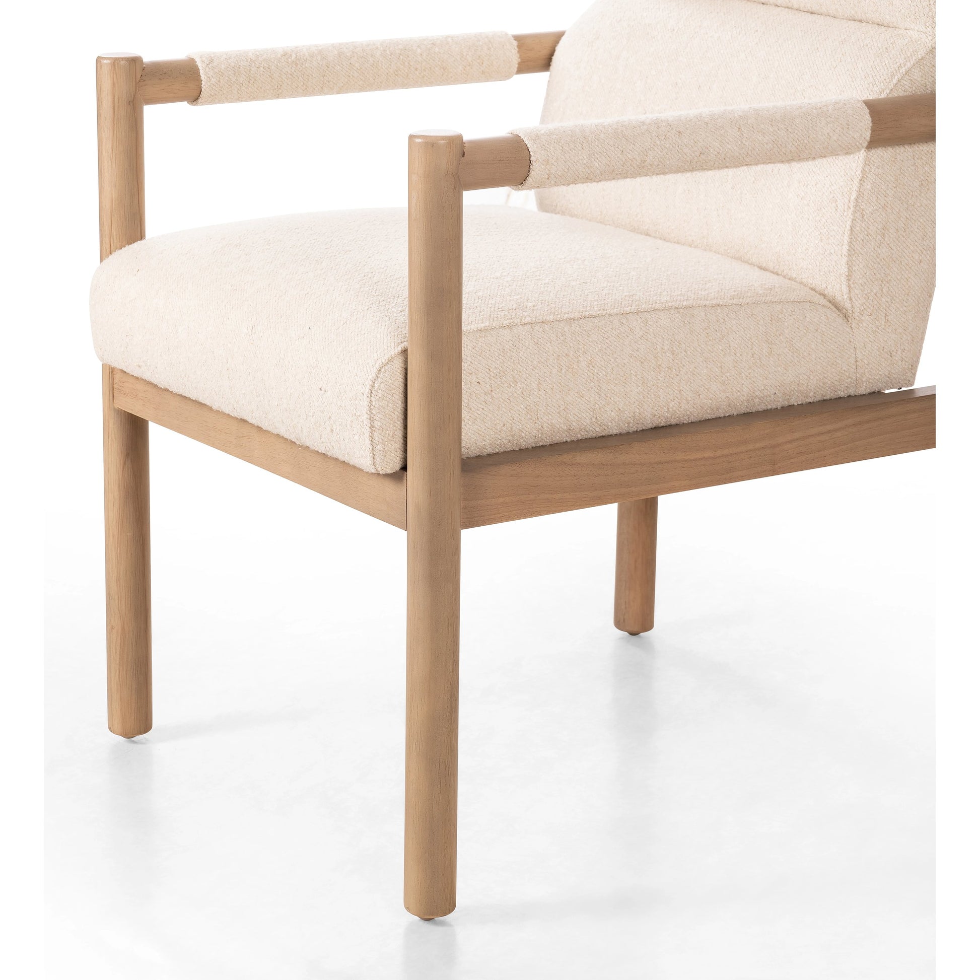 Kiano Dining Armchair by Four Hands in charter oatmeal and washed natural parawood. Made from 69% polyester, 23% acrylic, 8% flax, linen, solid parawood, 100% polyester in a modern style.
