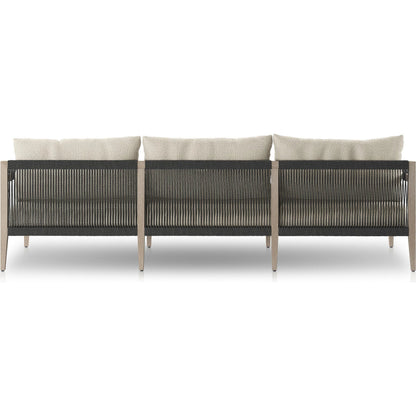 Sherwood Outdoor Sofa, Weathered Grey by Four Hands. Made from 100% olefin, solid fsc®-certified teak, 100% polypropylene in a coastal style.