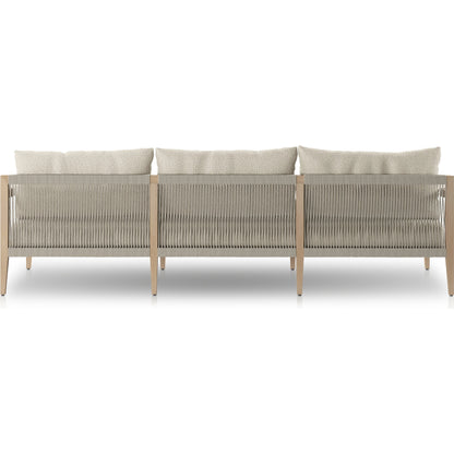 Sherwood Outdoor Sofa, Washed Brown by Four Hands. Made from 100% olefin, solid fsc®-certified teak, 100% polypropylene in a coastal style.