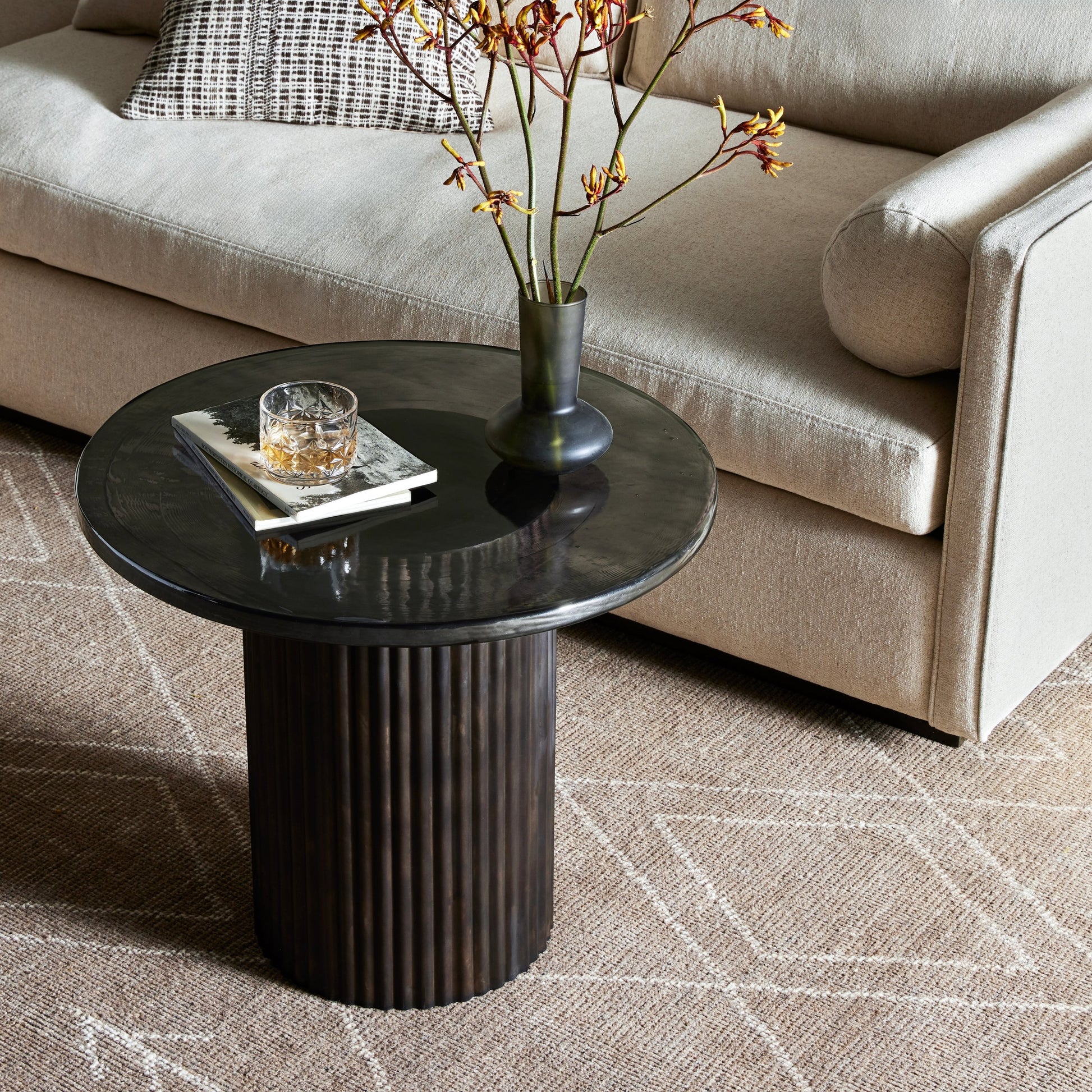 Ruben End Table by Four Hands in rustic brown, smoked black cast glass. Made from cast glass, iron in a modern style.
