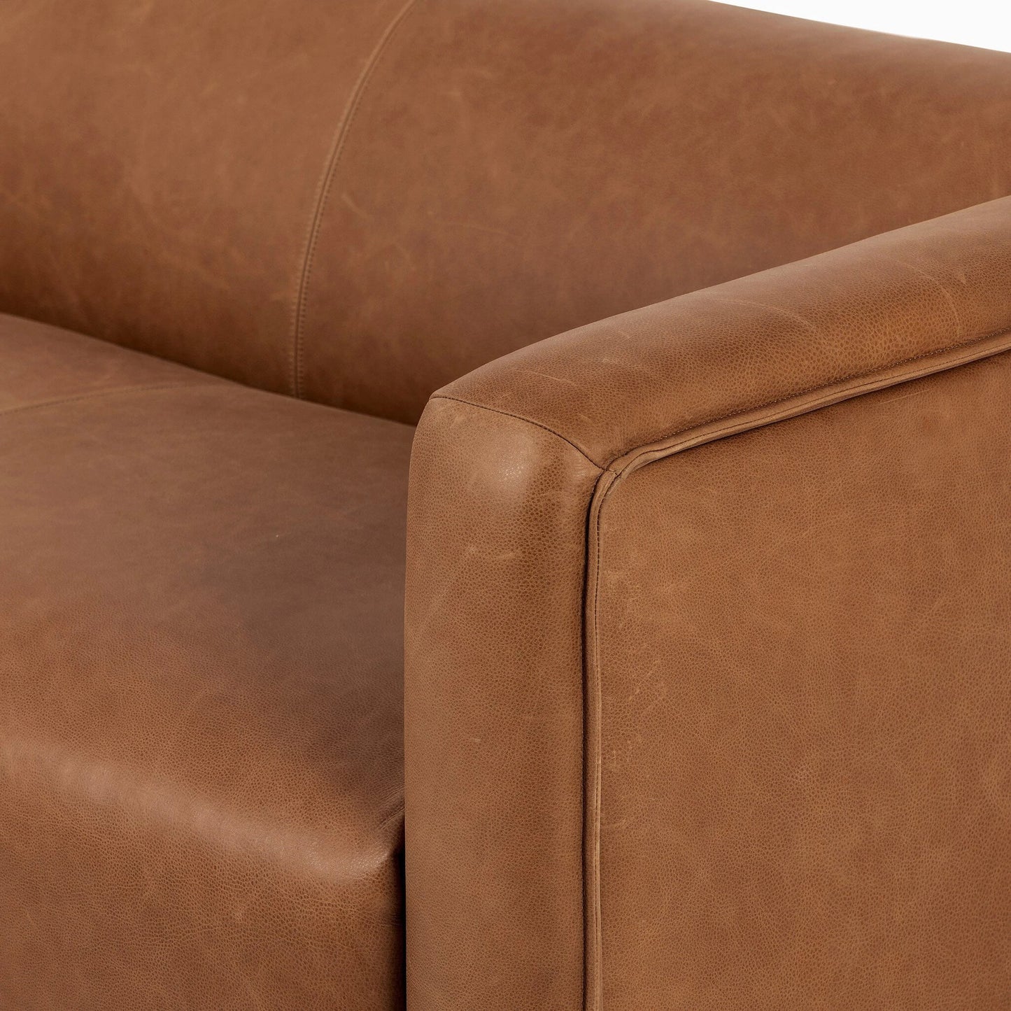 008 SI-2137704 | Closeup | Wellborn Sofa by Four Hands in palermo cognac. Made from top grain leather, poplar plywood, 100% polyester in a modern style.