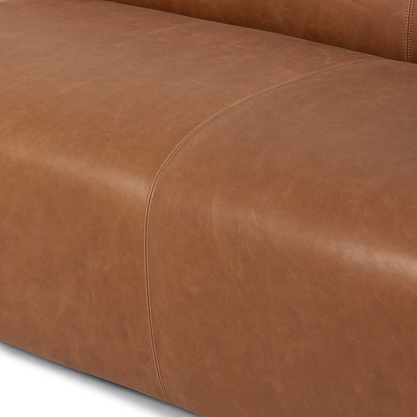 009 SI-2137704 | Closeup | Wellborn Sofa by Four Hands in palermo cognac. Made from top grain leather, poplar plywood, 100% polyester in a modern style.