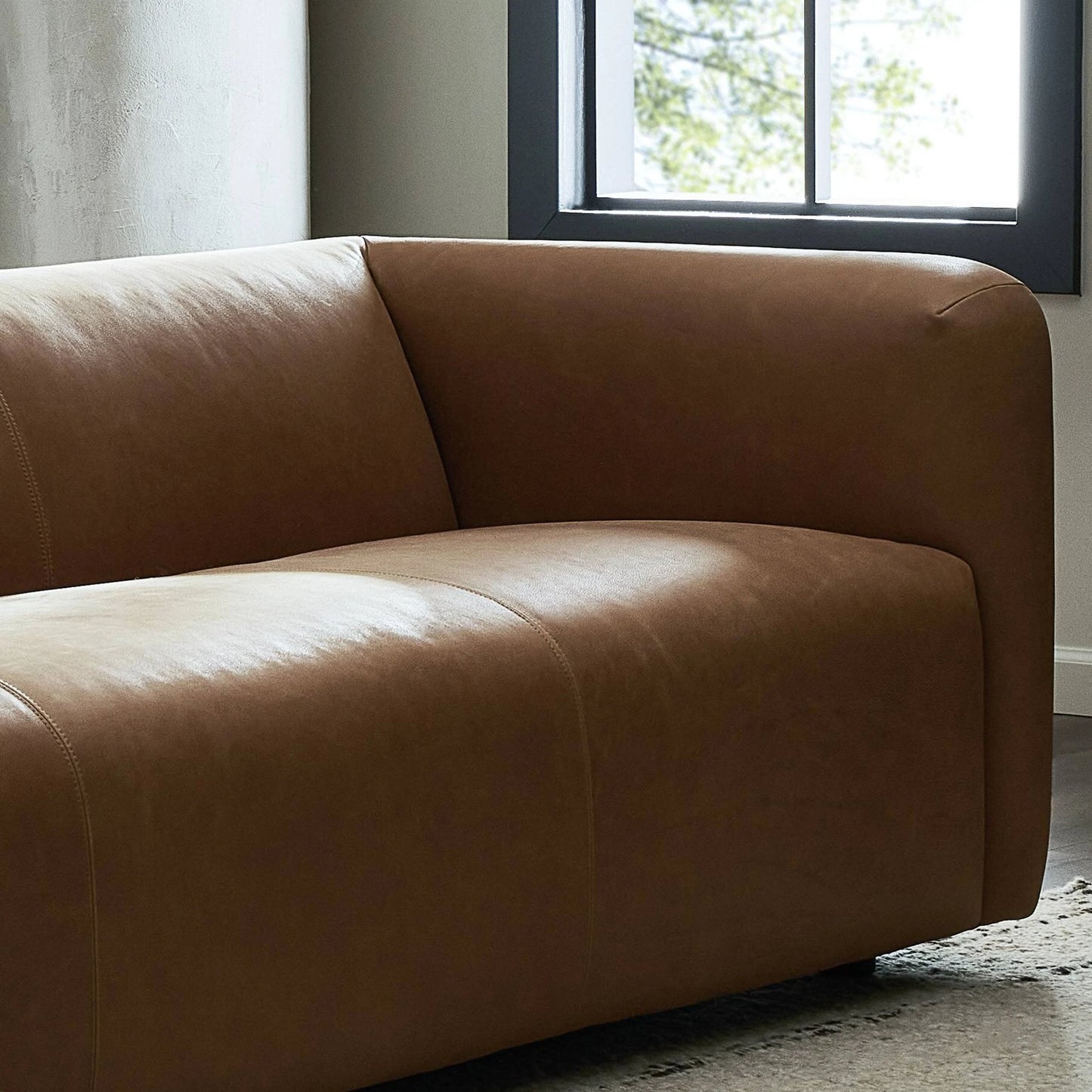 013 SI-2137704 | Closeup | Wellborn Sofa by Four Hands in palermo cognac. Made from top grain leather, poplar plywood, 100% polyester in a modern style.