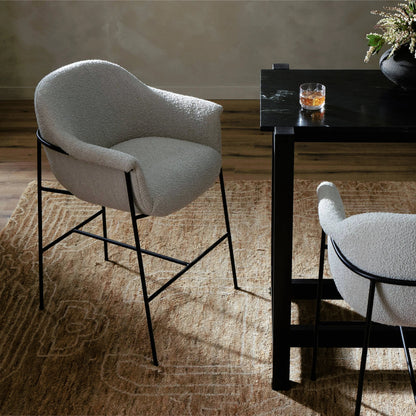 Suerte Bar + Counter Stool by Four Hands in knoll sand, matte ebony and knoll sand. Made from 95% polyester, 5% acrylic, iron, 100% polyester in a modern style.