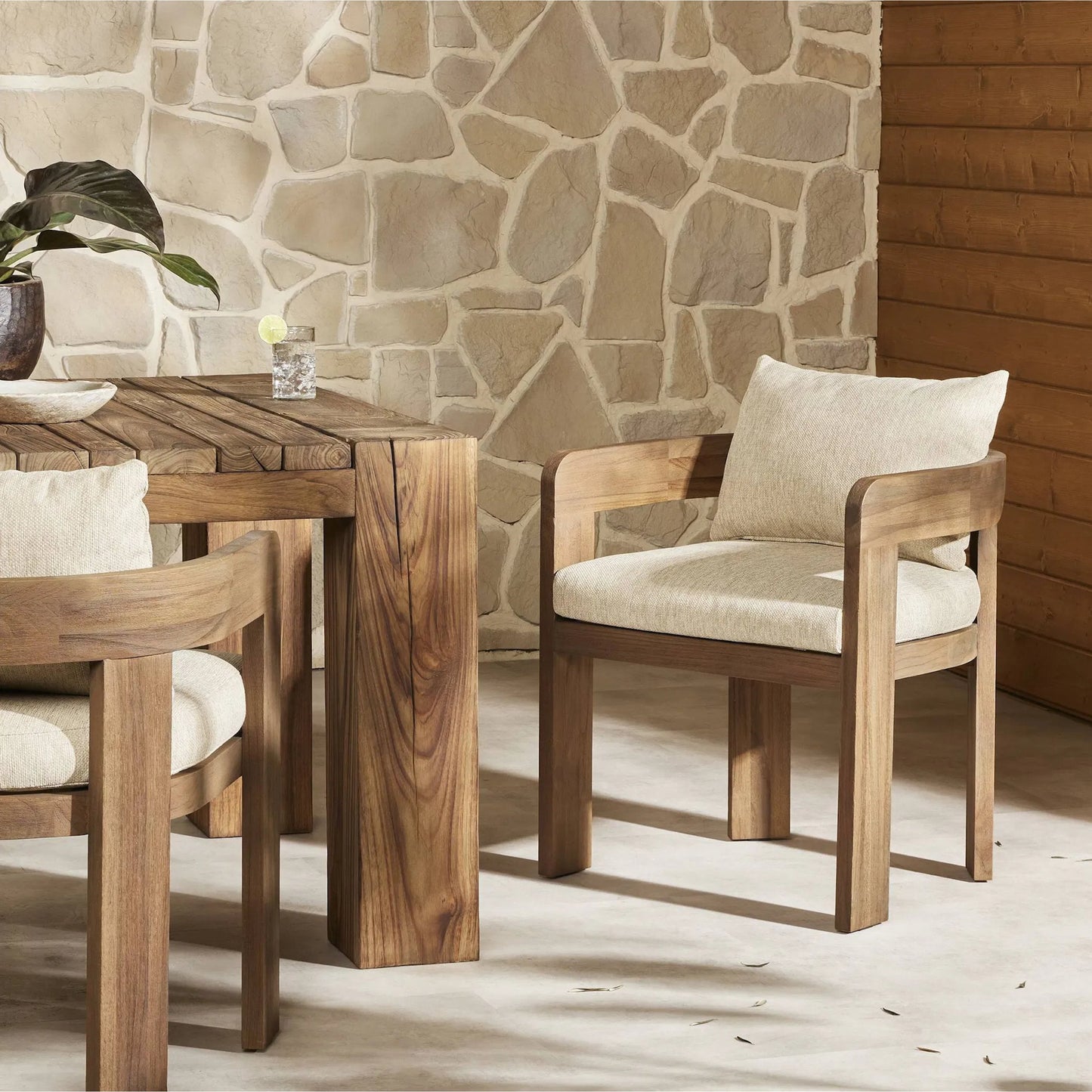036 SI-2257095 | Lifestyle | Jackson Outdoor Dining Chair by Four Hands. Made from 100% olefin, solid fsc®-certified teak, 90% polyester fiber, 10% polyester fiber batting in a modern style.