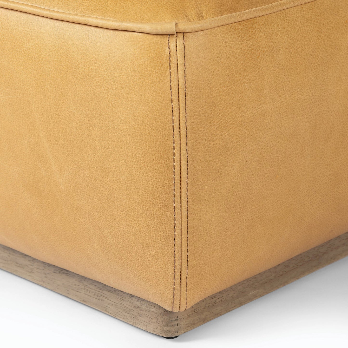 014 SI-2158481 | Closeup | Sinclair Square Ottoman-21" by Four Hands in palermo butterscotch, distressed natural. Made from top grain leather, solid parawood, 100% polyester in a modern style.