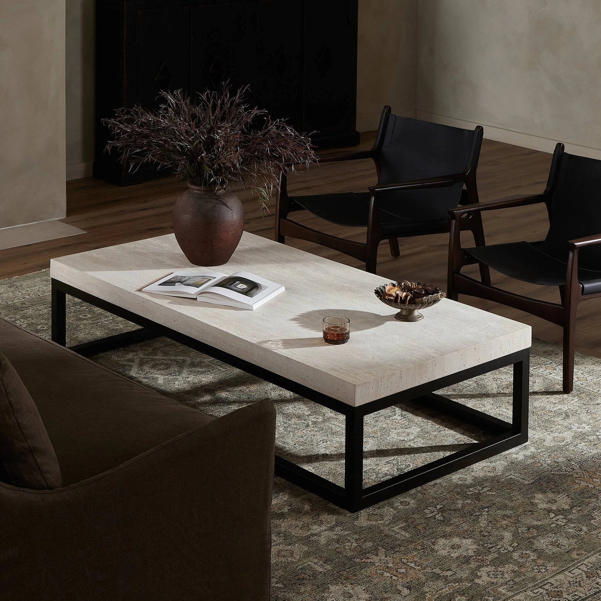 The Rectangular Coffee Table by Four Hands in travertine, bronze pebble texture. Made from solid travertine, iron in a modern style.