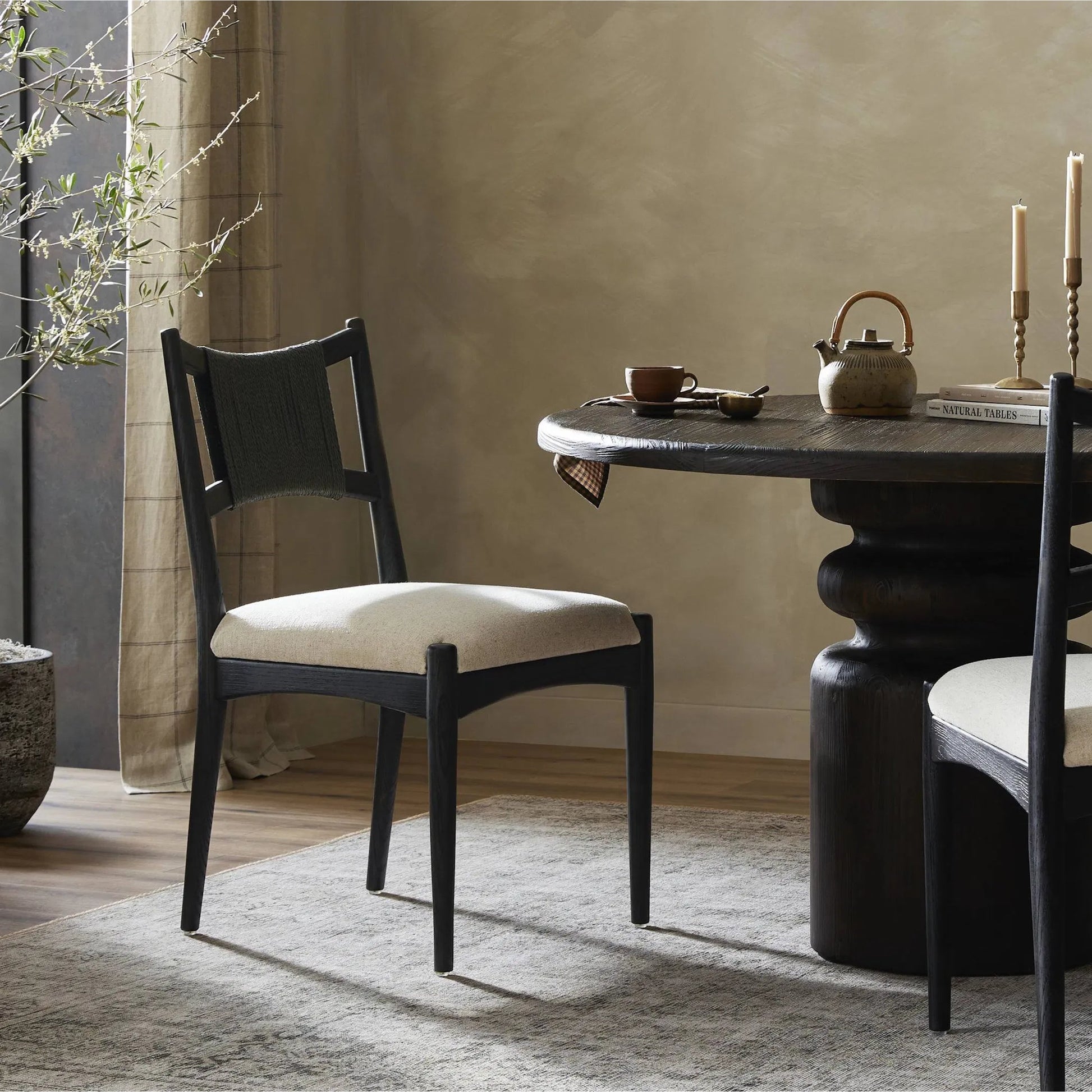 Haddon Dining Chair by Four Hands. Made from 39% linen, 35% cotton, 26% polyester, solid nettlewood, rush in a unique style.