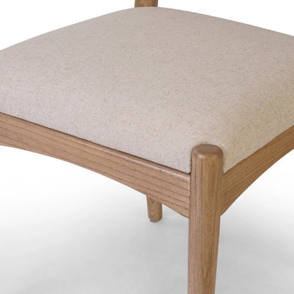 Haddon Dining Chair by Four Hands. Made from 39% linen, 35% cotton, 26% polyester, solid nettlewood, rush in a unique style.