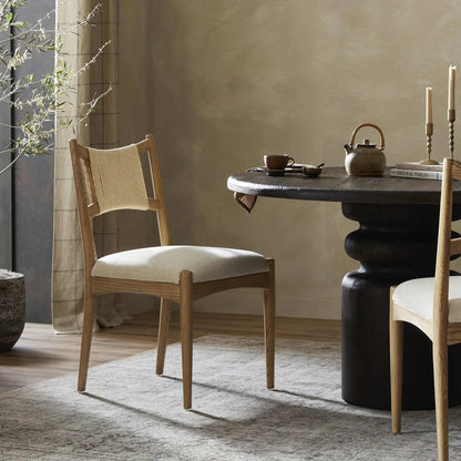 Haddon Dining Chair by Four Hands. Made from 39% linen, 35% cotton, 26% polyester, solid nettlewood, rush in a unique style.