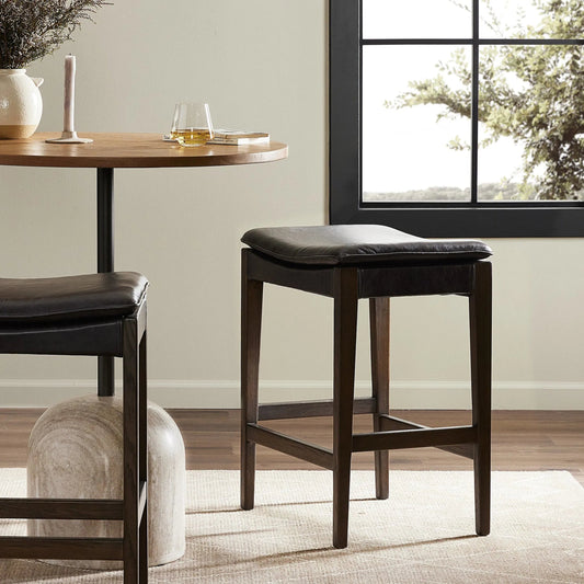 Aya Bar Stool by Four Hands in sonoma black and burnt oak. Made from top grain leather, solid oak, 100% polyester in a modern style.