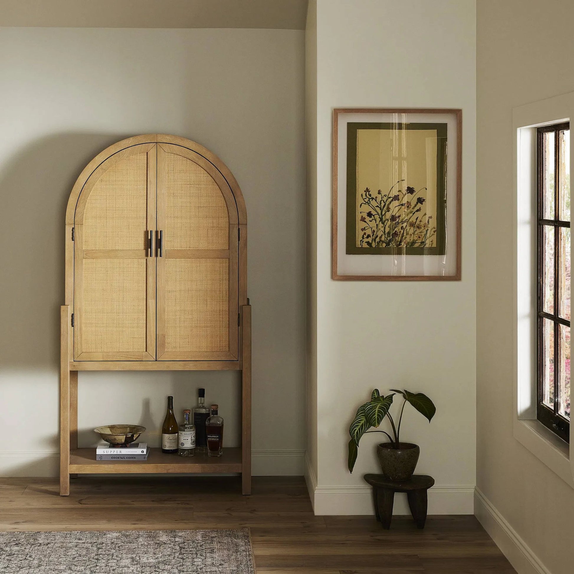 Dulane Bar Cabinet by Four Hands in light natural parawood veneer. Made from parawood veneer, cane, engineered hardwood in a transitional style.