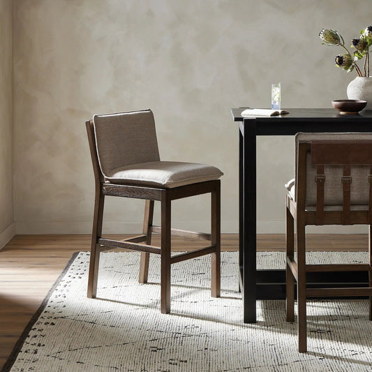 Wilmington Counter Stool by Four Hands in alcala fawn and almond nettlewood, sonoma coco. Made from 70% polyester, 20% viscose (rayon), 10% flax, linen, solid nettlewood, top grain leather in a modern style.