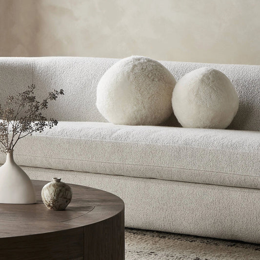 Balle Shearling Pillow Set by Four Hands in white shorn sheepskin. Made from 100% sheared sheepskin, down alternative fiber, 100% polyester in a transitional style.