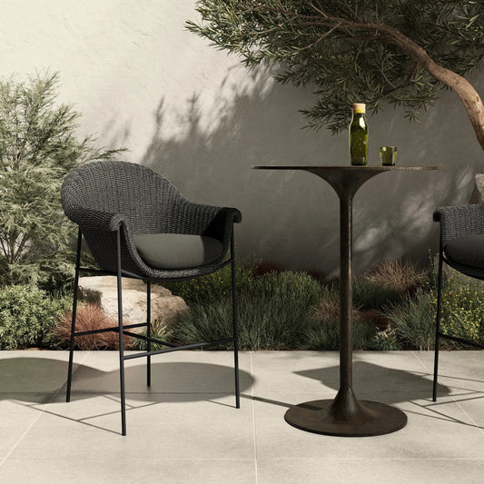 Suerte Outdoor Bar Stool by Four Hands. Made from 100% acrylic, iron, 100% polyethylene in a rustic style.