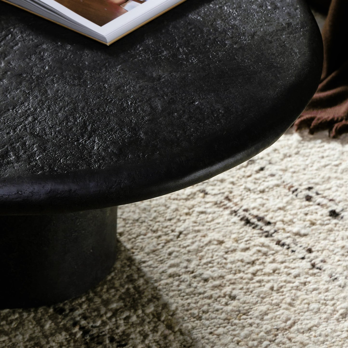 008 SI-2158066 | Lifestyle | Bonnie Coffee Table by Four Hands in textured black concrete. Made from concrete in a modern style.