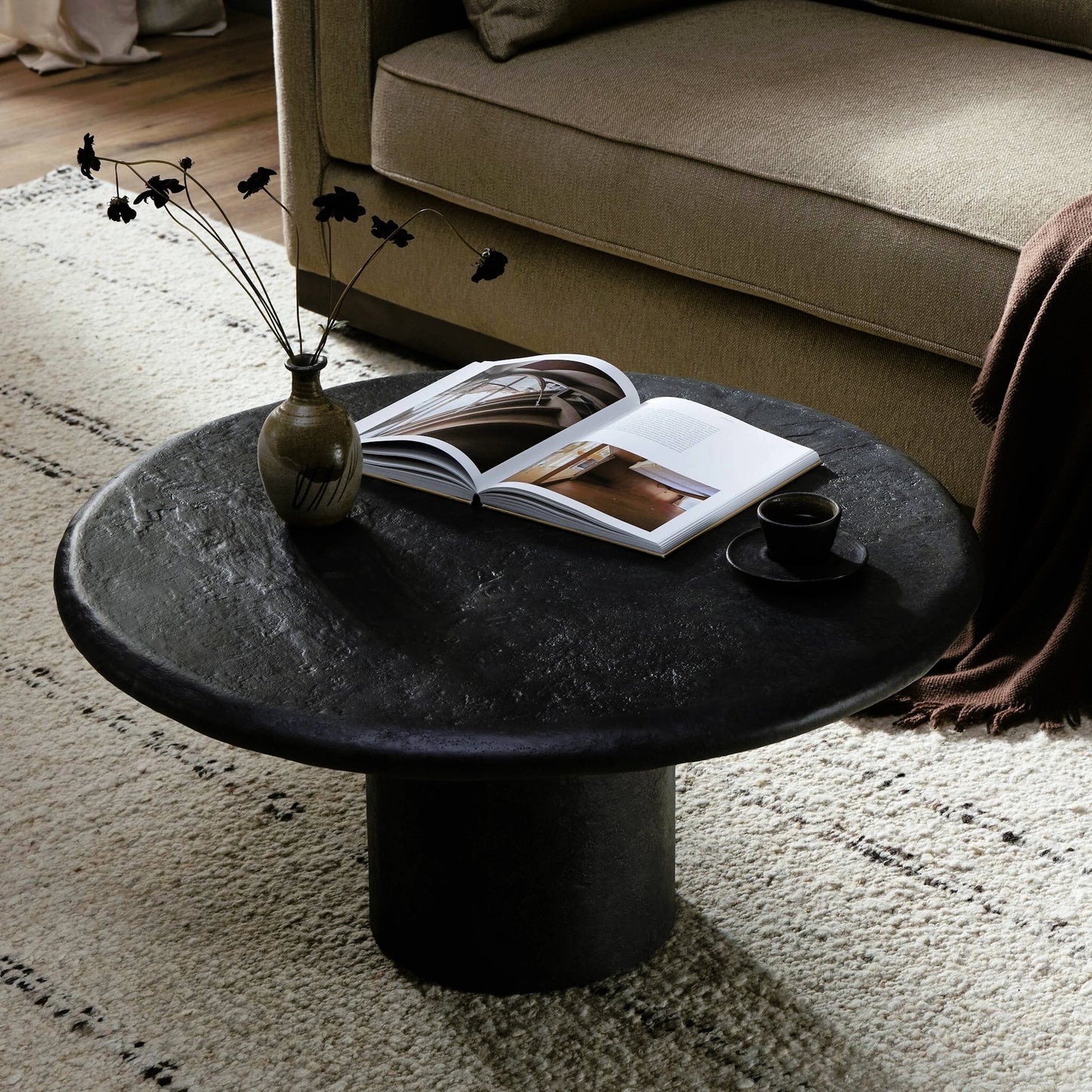 009 SI-2158066 | Lifestyle | Bonnie Coffee Table by Four Hands in textured black concrete. Made from concrete in a modern style.