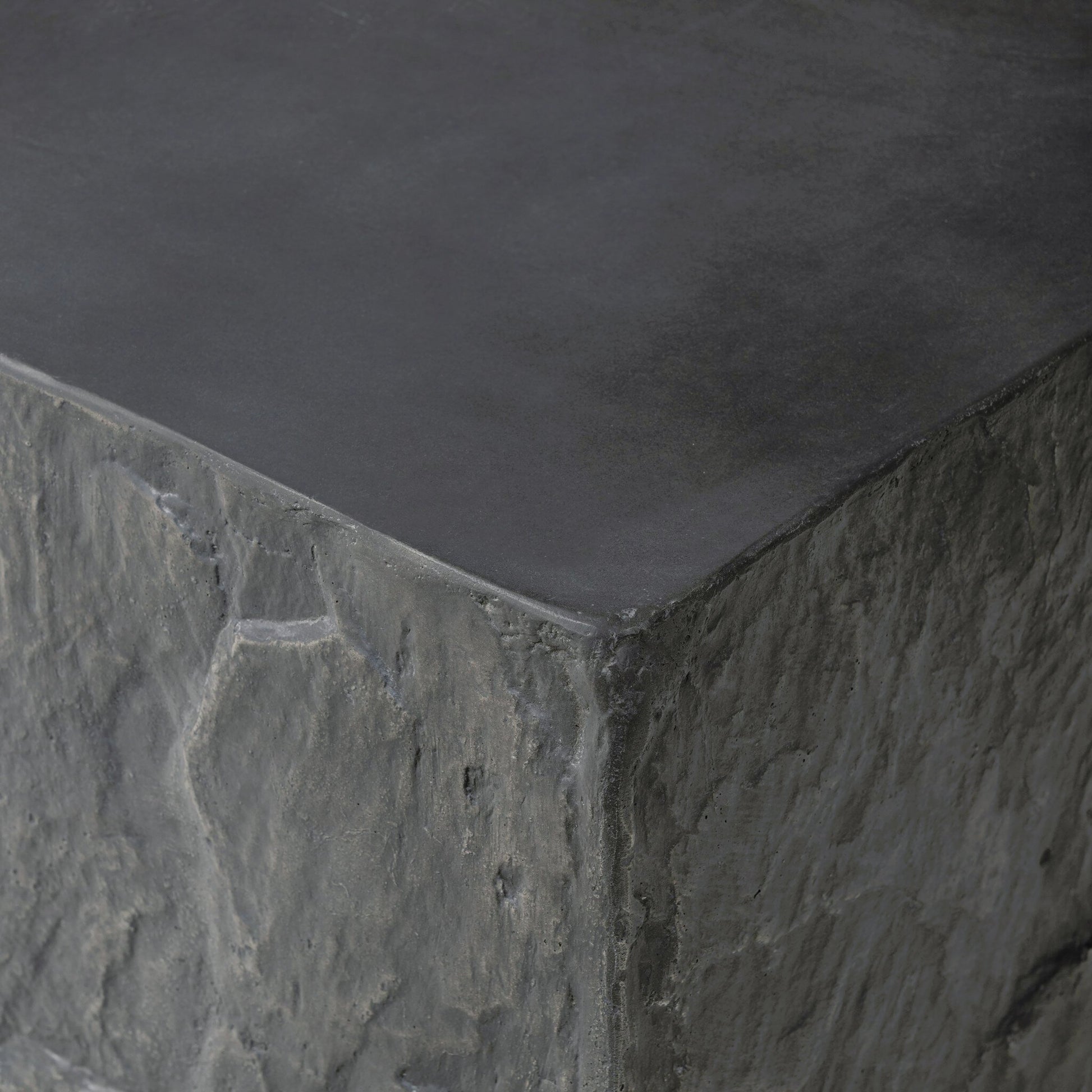 Lucius End Table by Four Hands in smooth black concrete, textured black concrete and smooth black concrete. Made from concrete in a modern style.