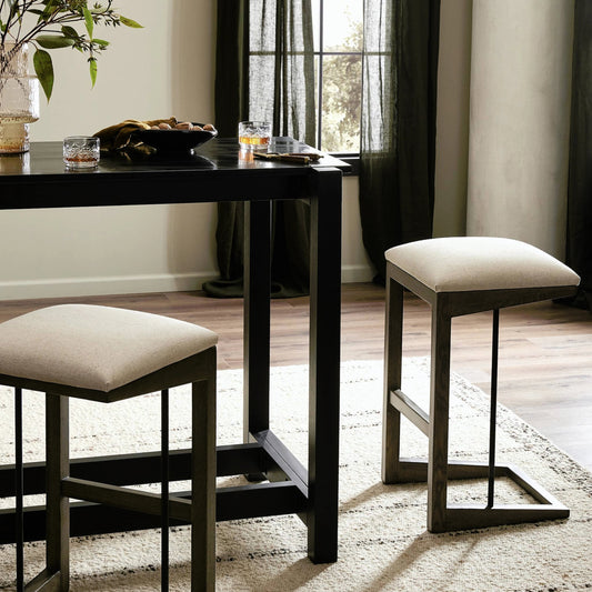 Finn Bar Stool by Four Hands in antwerp natural, sienna brown oak. Made from 39% linen, 35% cotton, 26% polyester, solid oak, iron in a modern style.